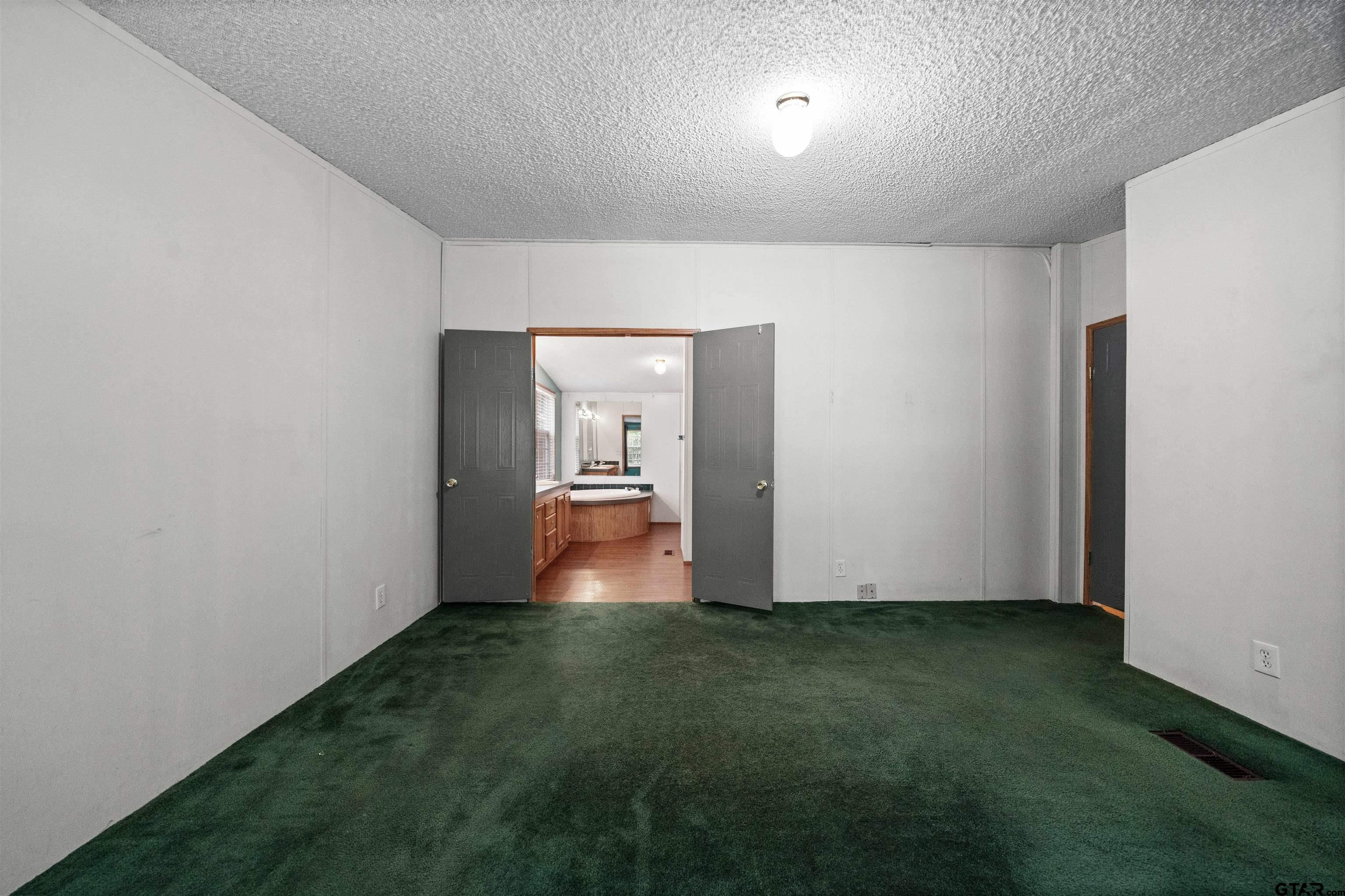 155 Piney Point Drive Murchison, TX 75778 - Photo 34 of 41 a view of a room with wooden floor and a bathroom