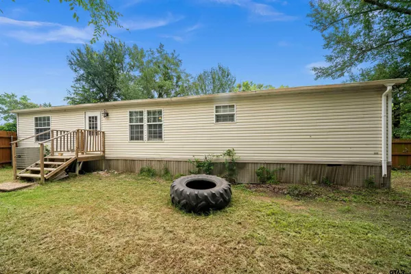 a backyard of a house with barbeque oven and seating space
