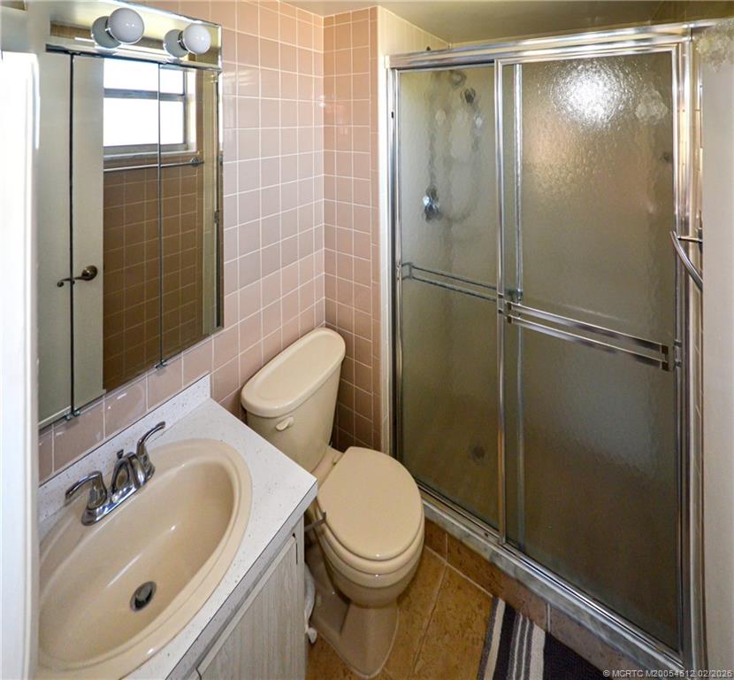 1963 Southwest Palm City Road, Unit F Stuart, FL 34994 - Photo 8 of 19 a bathroom with a sink toilet and shower