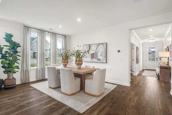 a living room with a large window and wooden floor