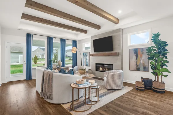 a living room with furniture large window and a fireplace
