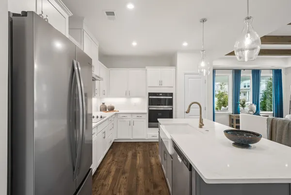 a kitchen with refrigerator cabinets and a sink