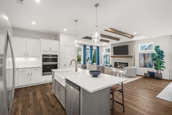 a kitchen with a sink a counter top space stainless steel appliances and a center island