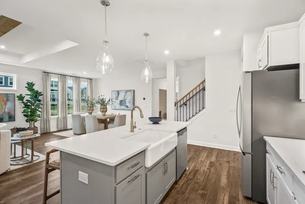 a view of kitchen with sink and refrigerator