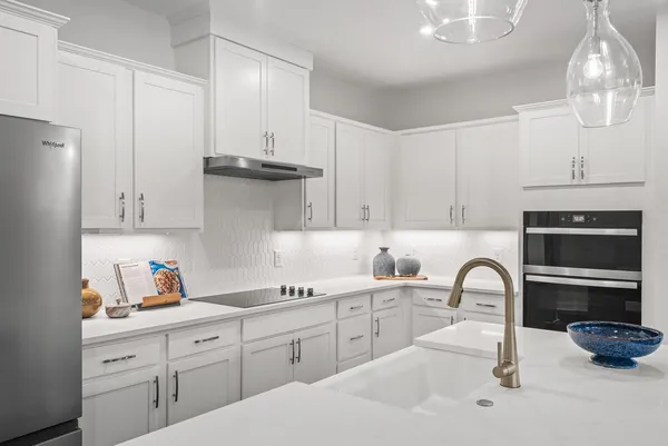 a kitchen with stainless steel appliances a sink a stove and cabinets