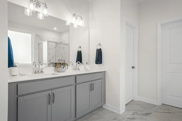 a bathroom with a double vanity sink and a mirror