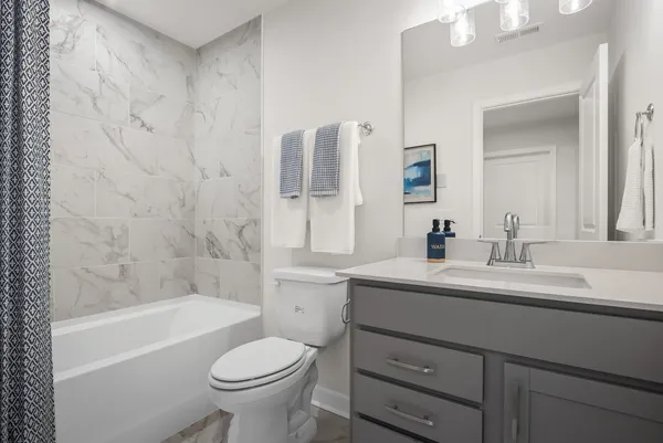 a bathroom with a sink a toilet and a bathtub