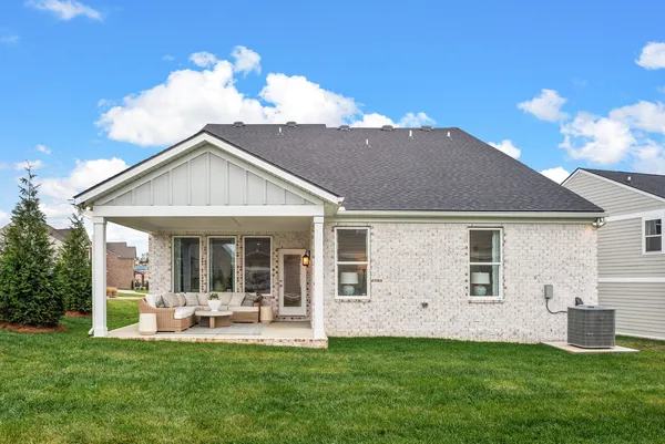 a view of a house with a yard and porch
