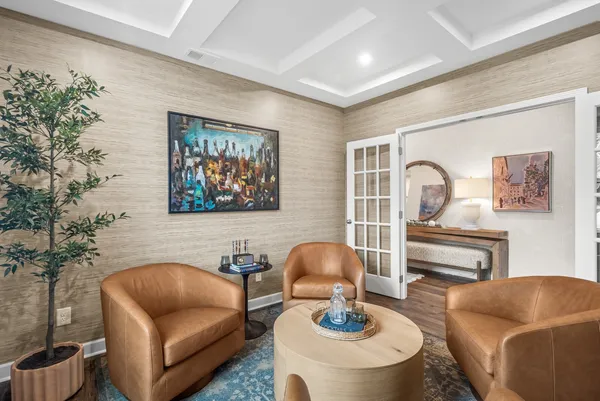a living room with furniture and a potted plant