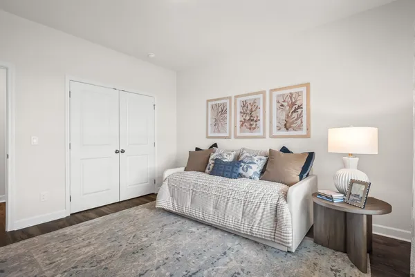 a living room with furniture and a lamp