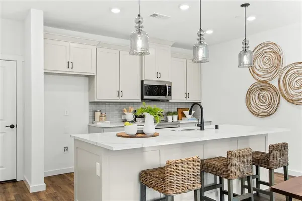 a kitchen with a dining table and chairs