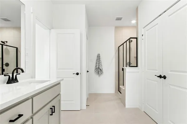 a bathroom with a double vanity sink a mirror and shower