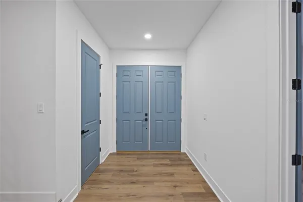 a view of hallway with wooden floor