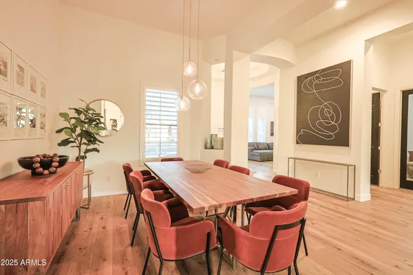 a view of a dining room with furniture and chandelier