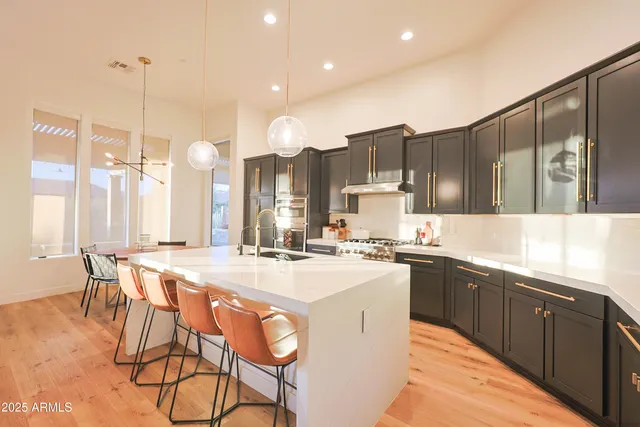 a large kitchen with lots of counter space a sink and appliances
