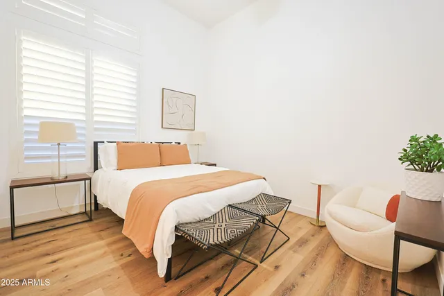 a bedroom with a bed and chair