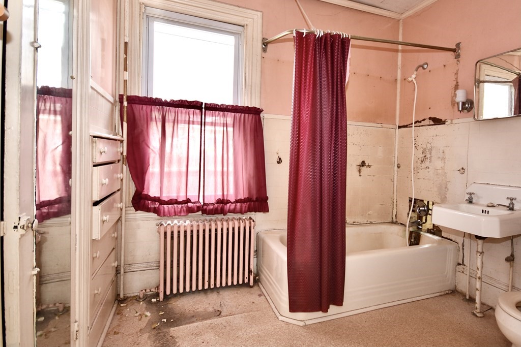 215 High Street Wareham, MA 02571 - Photo 16 of 19 a view of a bedroom with a window and a bath tub