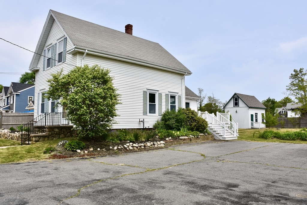 215 High Street Wareham, MA 02571 - Photo 10 of 19 a front view of a house with a yard and garage