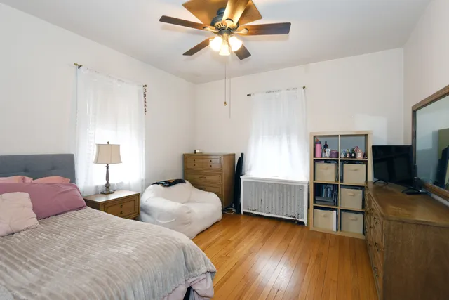 a bedroom with two bed and a flat screen tv