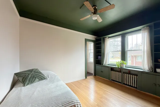 a bedroom with a bed and a large window