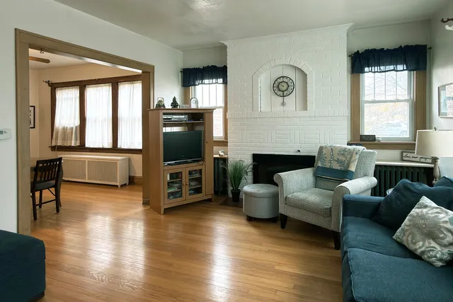a living room with fireplace furniture and a flat screen tv