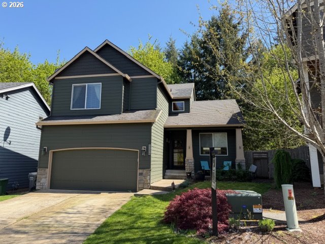 17376 Aubin Street Sandy, OR 97055 - Photo 1 of 21 a front view of a house with a garden and trees