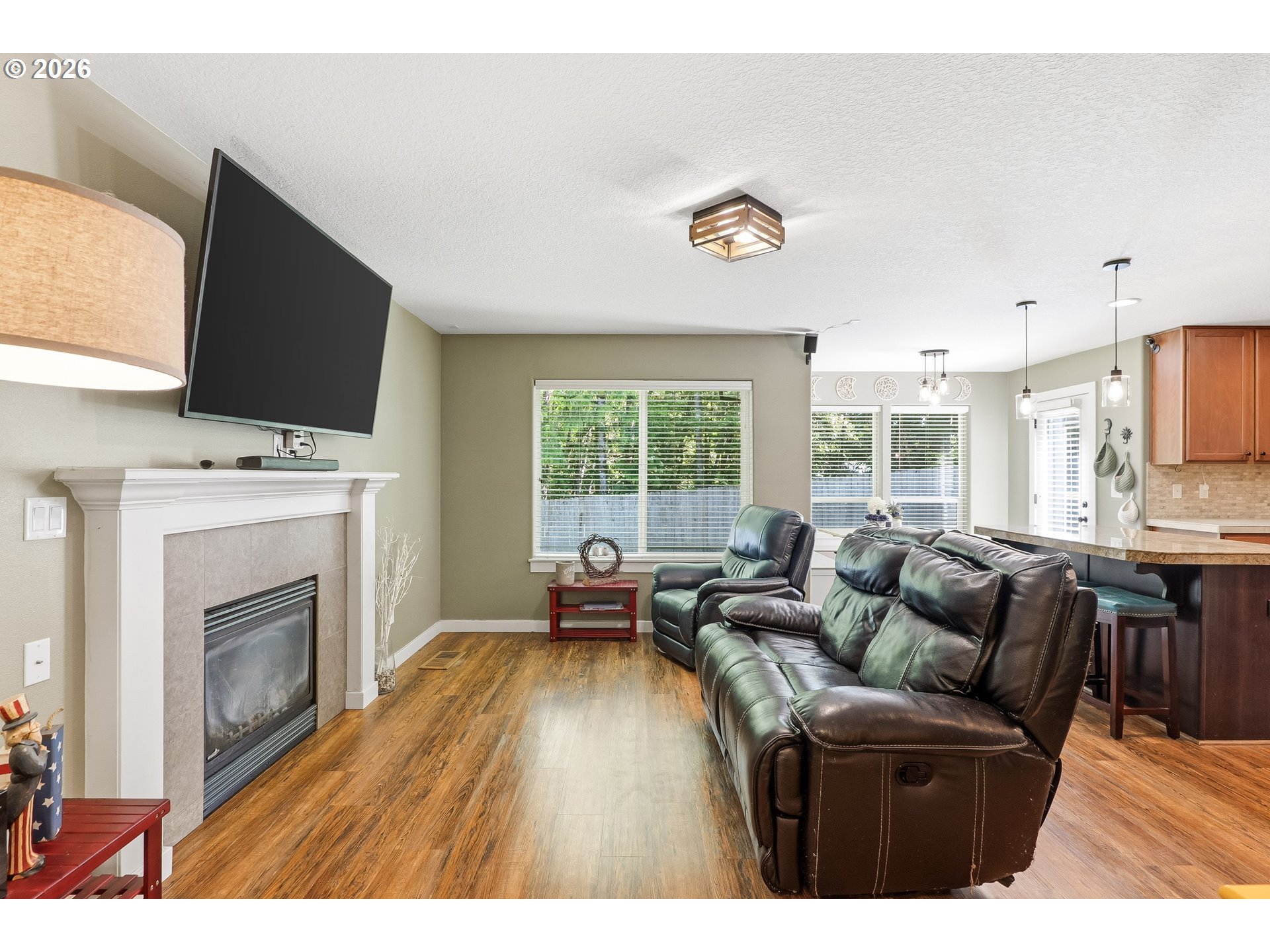 17376 Aubin Street Sandy, OR 97055 - Photo 11 of 21 a living room with furniture a fireplace and a flat screen tv