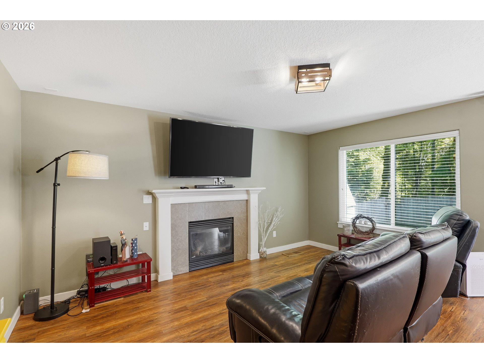 17376 Aubin Street Sandy, OR 97055 - Photo 12 of 21 a living room with furniture a fireplace and a flat screen tv