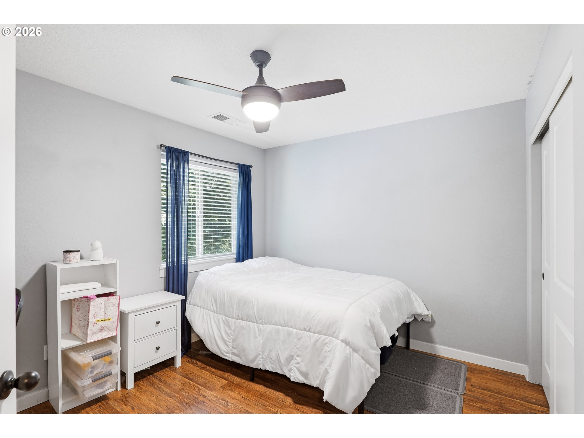 17376 Aubin Street Sandy, OR 97055 - Photo 13 of 21 a bedroom with a large bed and a chandelier