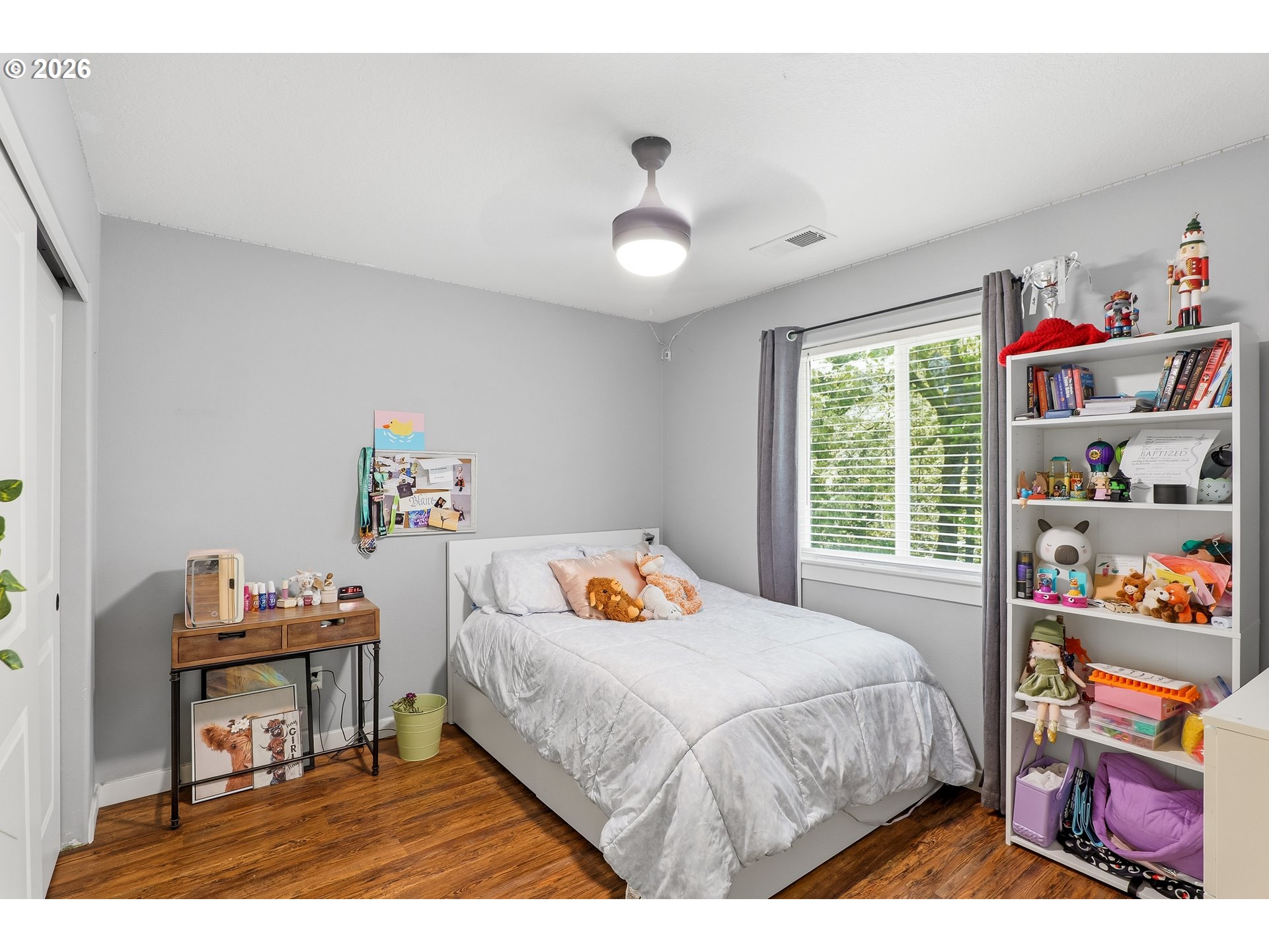 17376 Aubin Street Sandy, OR 97055 - Photo 15 of 21 a bedroom with a bed and a book shelf