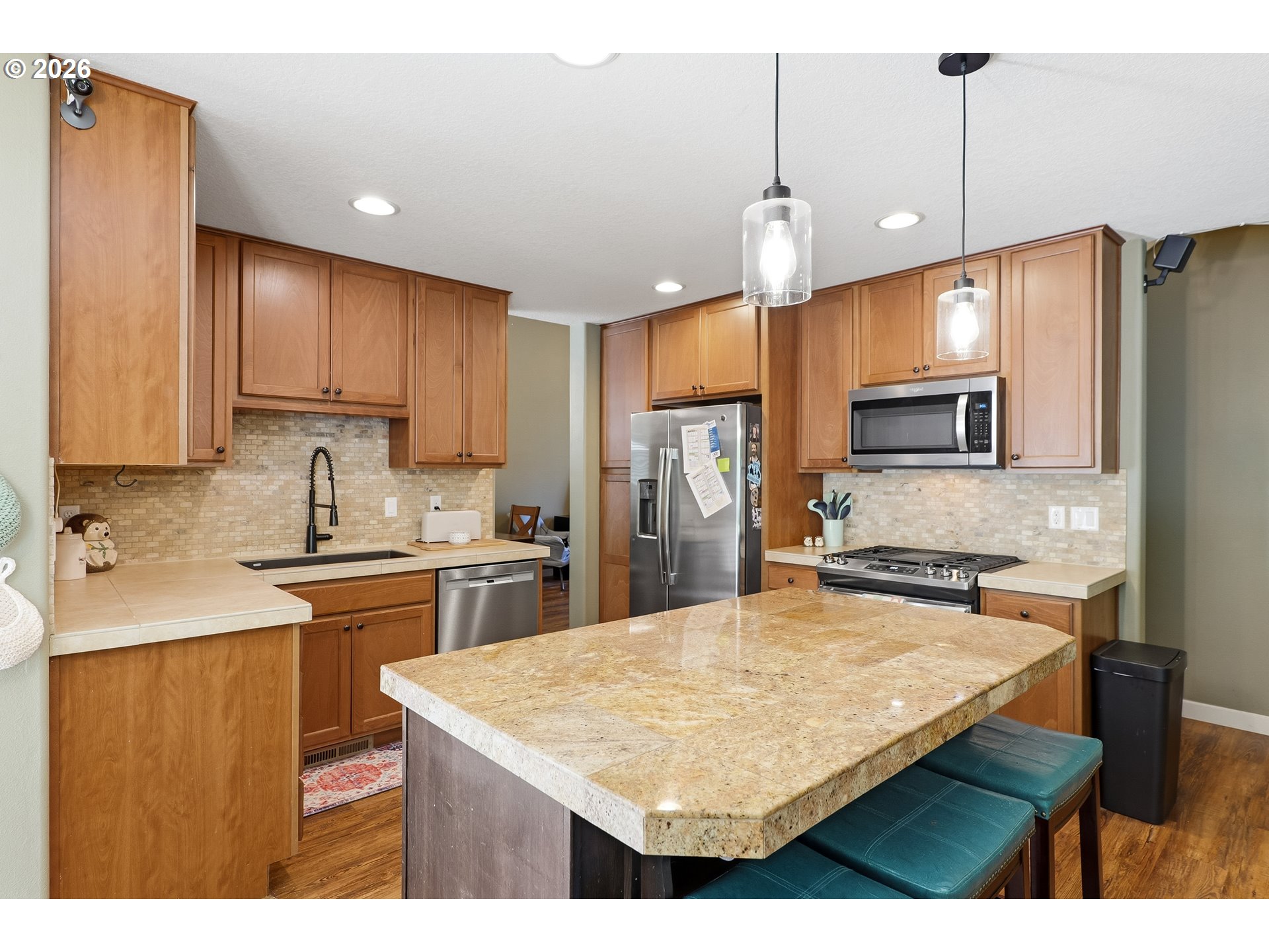 17376 Aubin Street Sandy, OR 97055 - Photo 7 of 21 a kitchen with kitchen island a sink counter top space appliances and cabinets