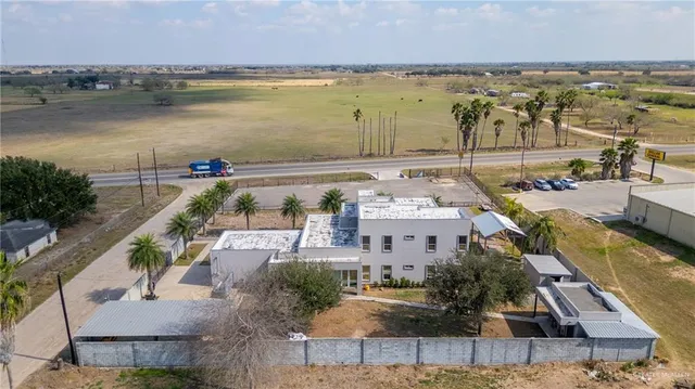 an aerial view of a house with garden space and outdoor seating