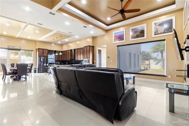 a living room with stainless steel appliances kitchen island granite countertop furniture and a kitchen view