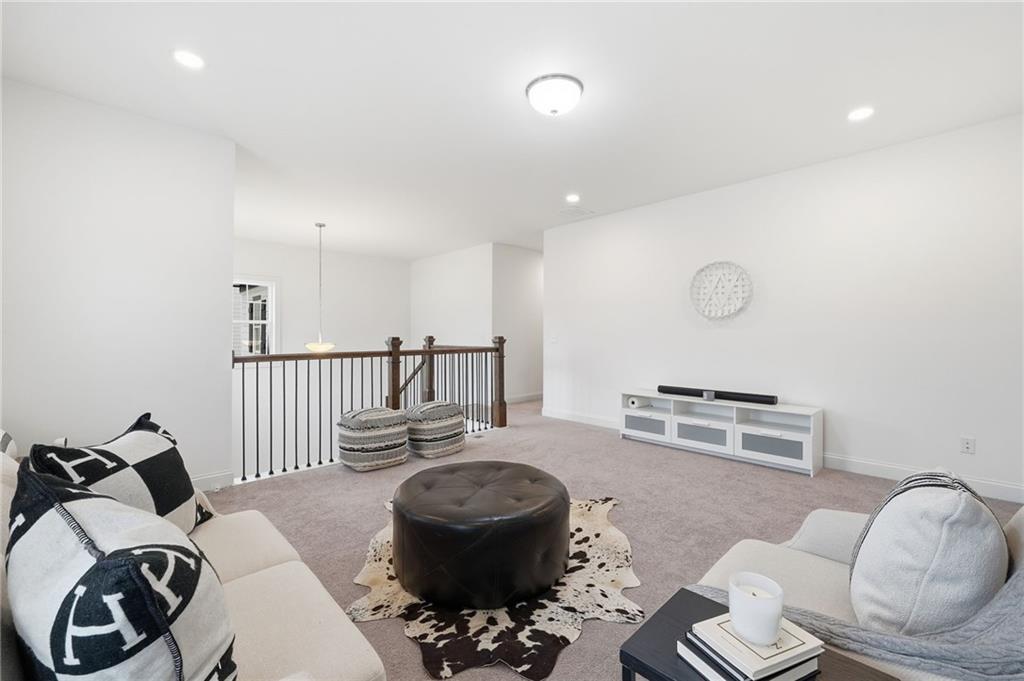 3180 Andover Street Cumming, GA 30028 - Photo 18 of 41 a bedroom with furniture and a wooden floor
