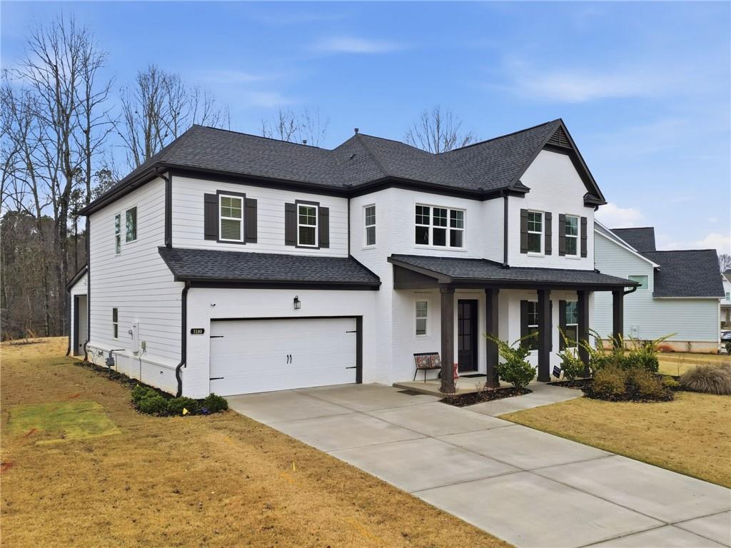 3180 Andover Street Cumming, GA 30028 - Photo 2 of 41 a front view of a house with a yard and garage