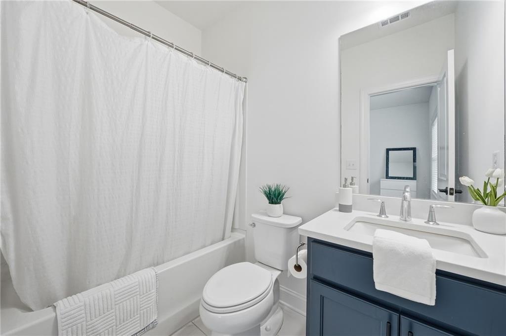 3180 Andover Street Cumming, GA 30028 - Photo 21 of 41 a bathroom with a toilet a sink and a mirror