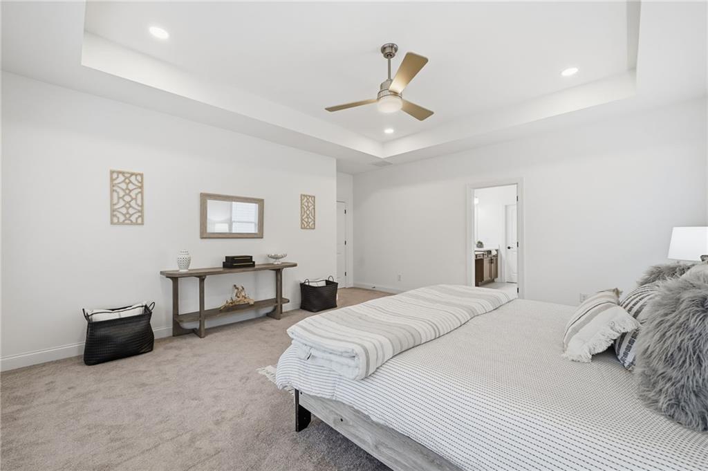 3180 Andover Street Cumming, GA 30028 - Photo 23 of 41 a bedroom with a bed and a chandelier