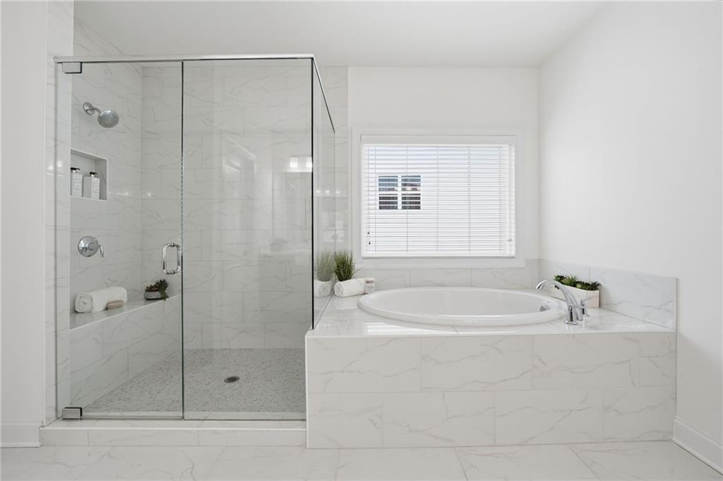 3180 Andover Street Cumming, GA 30028 - Photo 25 of 41 a bathroom with a bathtub and a shower