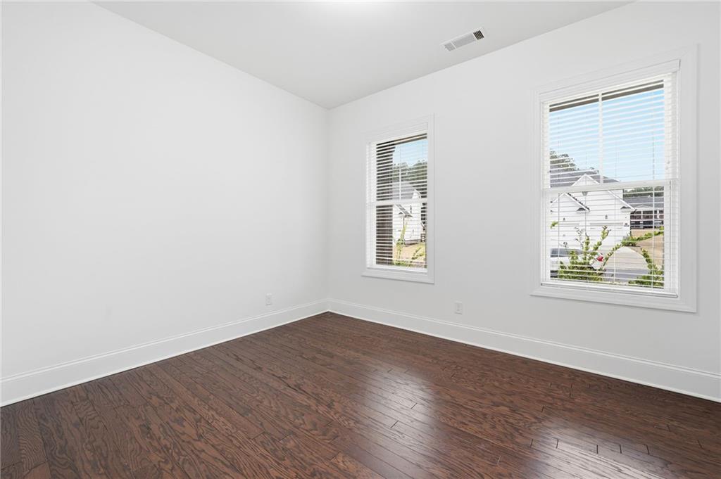 3180 Andover Street Cumming, GA 30028 - Photo 4 of 41 an empty room with wooden floor and windows
