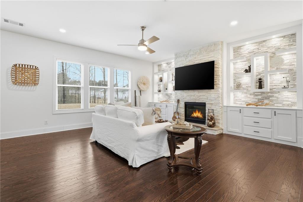 3180 Andover Street Cumming, GA 30028 - Photo 7 of 41 a living room with furniture a flat screen tv and a fireplace