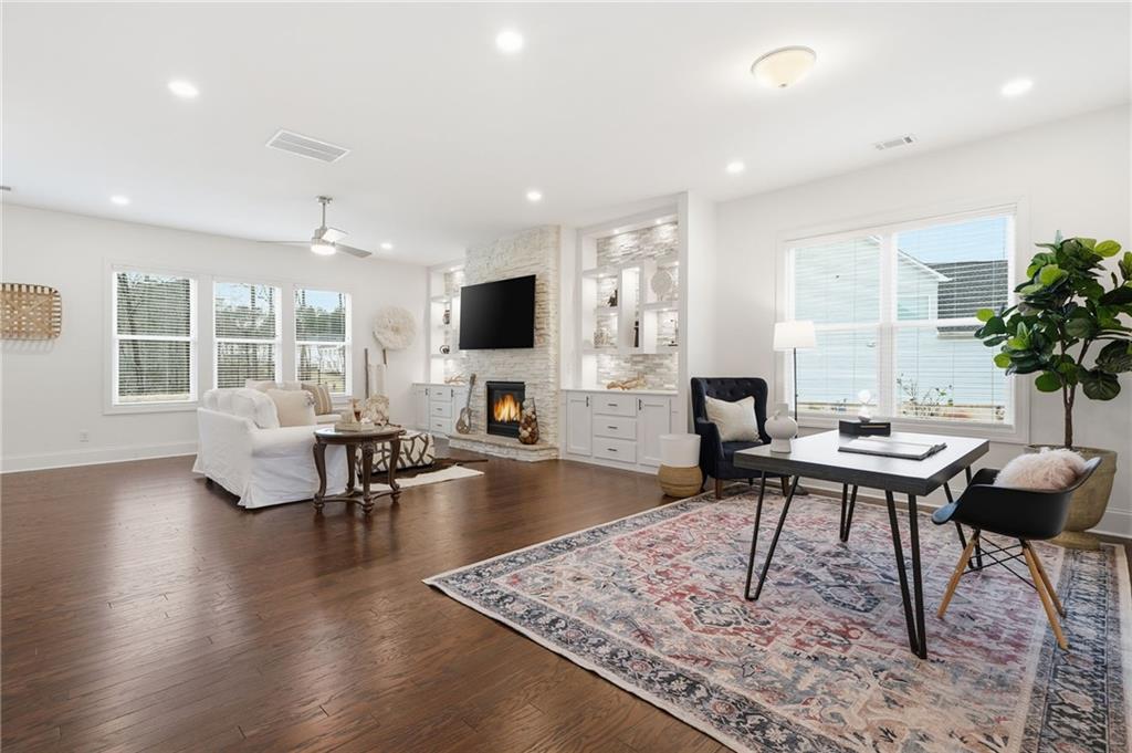 3180 Andover Street Cumming, GA 30028 - Photo 9 of 41 a living room with furniture a rug and a flat screen tv