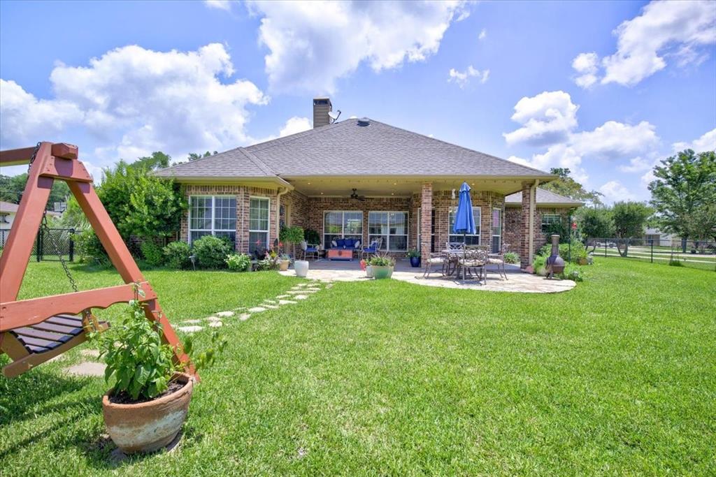 111 Trailwood Road Enchanted Oaks, TX 75156 - Photo 24 of 33 a view of an house with backyard porch and garden