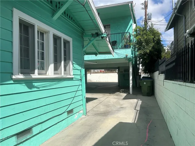 a front view of a house with a garden and plants