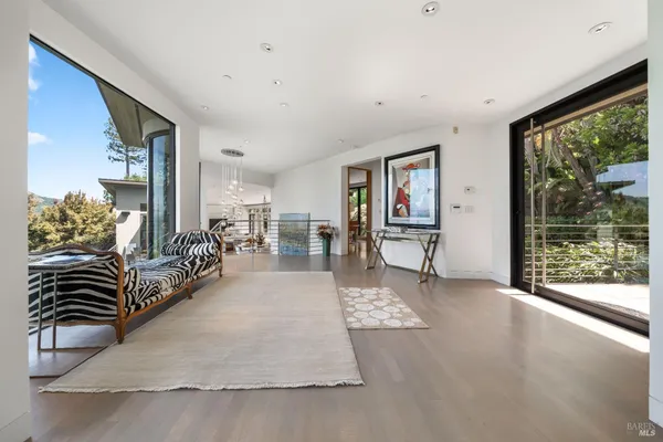 a living room with furniture a flat screen tv and a large window