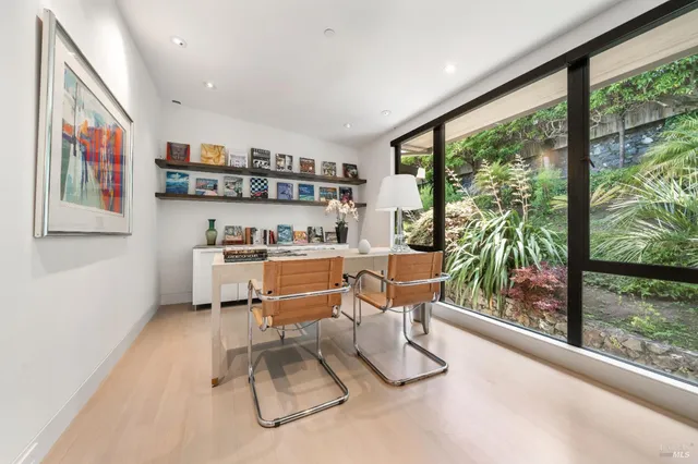 a living room with furniture and a large window with outer view