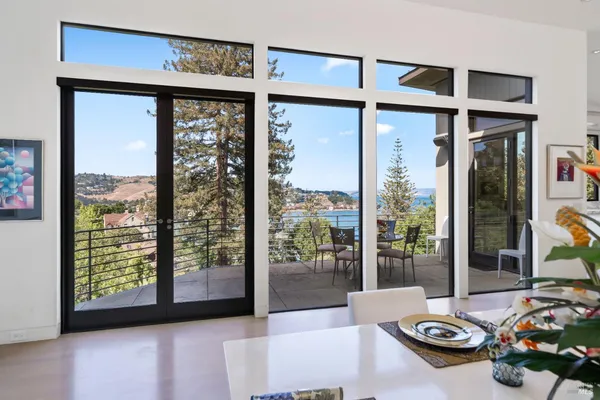 a large white kitchen with a large window and stainless steel appliances