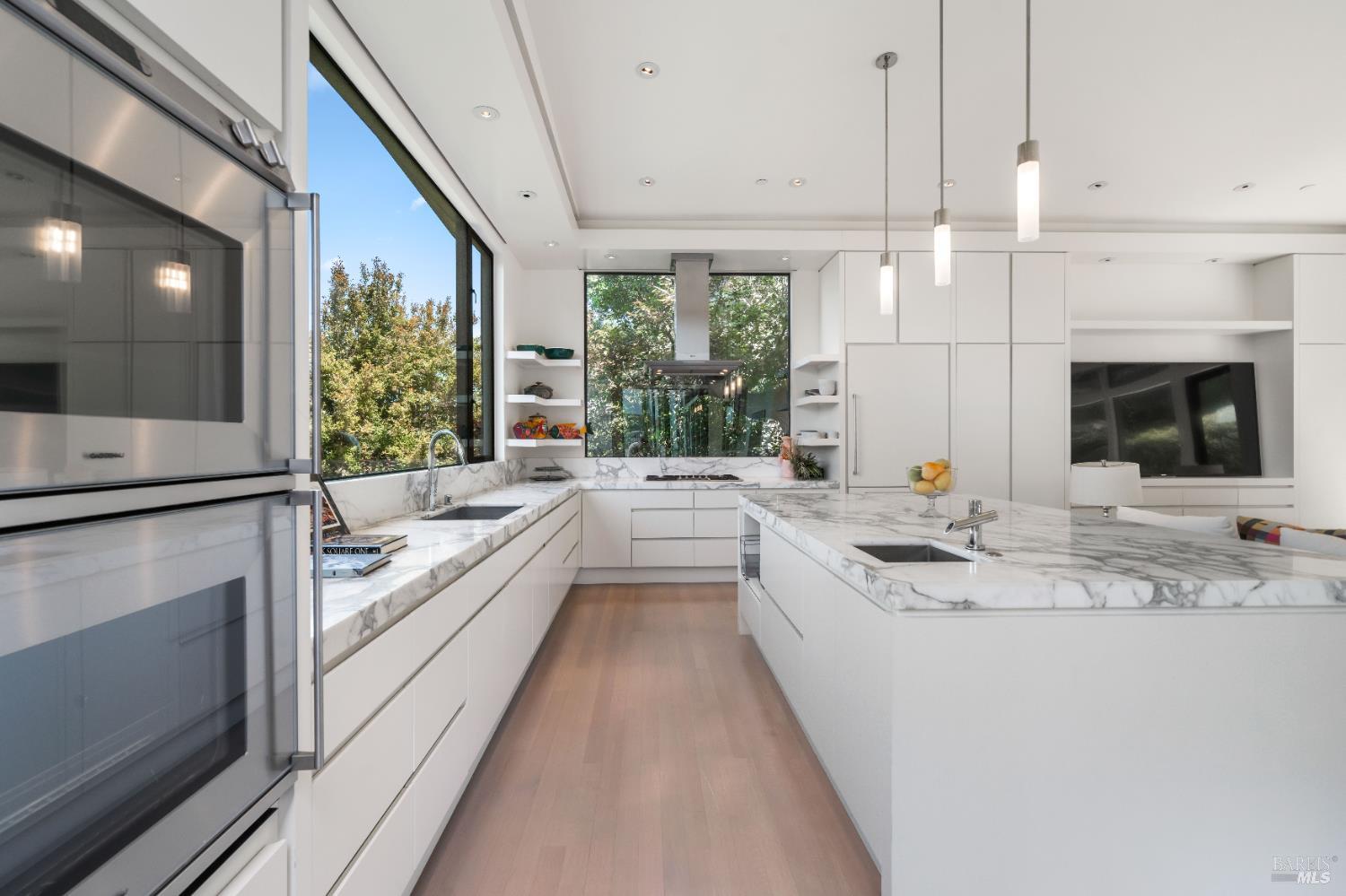 408 Golden Gate Avenue Belvedere, CA 94920 - Photo 30 of 71 a large white kitchen with a large window and stainless steel appliances