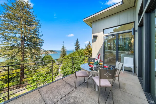 a view of a dining room with furniture a chandelier and wooden floor