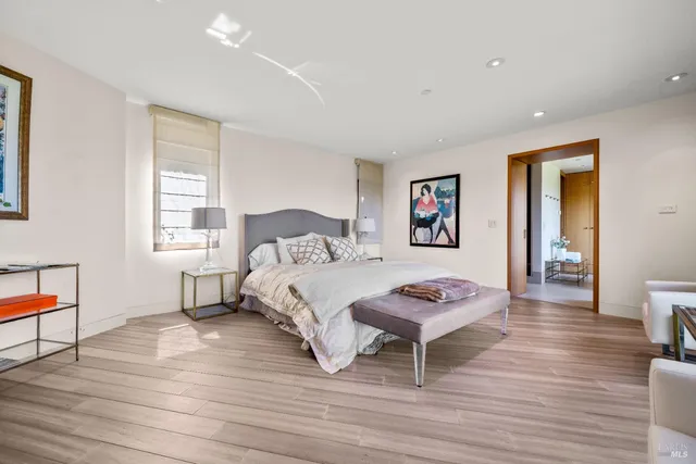 a bedroom with a bed and a large window