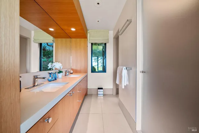 a living room with furniture fireplace and a large window